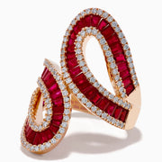 The 14K Rose Gold Ruby and Diamond Bypass Statement Ring features two overlapping rose gold loops adorned with rows of rubies and bordered by sparkling diamonds, creating an elegant and luxurious look against a plain white background.