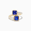 The Nahla 14K Yellow Gold Tanzanite and Diamond Bypass Ring features two square-cut tanzanites on each end of an open band, accented with small rectangular diamonds along the yellow gold band.