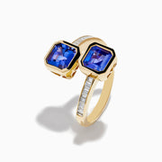 The Nahla 14K Yellow Gold Tanzanite and Diamond Bypass Ring features two square-cut tanzanites on each end of an open band, accented with small rectangular diamonds along the yellow gold band.