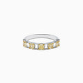 The Canare 18K Two Tone Gold White and Yellow Gold Diamond Band Ring features alternating rectangular yellow and clear diamonds set in a row along the band, shown on a white background.