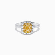The Canare 18K Two Tone Gold White and Yellow Diamond Ring features a large rectangular yellow gemstone, double halo of white diamonds, and diamond accents on the elegant band.