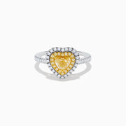 The Canare 18K Two Tone Gold White & Yellow Diamond Heart Ring features a heart-shaped yellow gemstone center with a double halo of yellow and clear diamonds, inspired by elegant Canare designs.