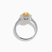 A close-up of the Canare 18K Two Tone Gold White & Yellow Diamond Ring, highlighting its oval yellow center stone encircled by two halos of white diamonds and additional diamonds set along the elegant silver band.