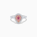 The 18K Two Tone Gold White and Pink Diamond Ring features a teardrop-shaped center with a pink gemstone, surrounded by pink and white stones, set on a band adorned with sparkling white diamonds.