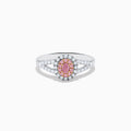 The 18K Two Tone Gold White and Pink Diamond Ring features an oval pink center gemstone, a halo of white and pink stones, and additional white stones set along the split band.
