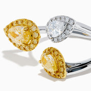 The 18K Two Tone Open Shank Yellow and White Diamond Pear Bouquet Ring features an open band with yellow gemstones bordered by smaller yellow gems and a white gemstone encircled by white diamonds.