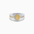 The Men's 18K Two Tone Gold Yellow and White Diamond Signet Ring showcases an oval yellow gemstone at the center, framed by a halo of clear diamonds, with rows of yellow stones along each side of the band.