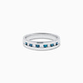 The Mens Bella Bleu 14K White Gold White and Blue Diamond Ring features alternating blue and white diamonds set in a channel across the top, displayed on a plain white background.