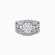 The Bouquet 14K White Gold Diamond Cluster Ring 1.98 TCW features a striking round diamond cluster at the center, accented by additional diamonds on a split shank band for dazzling brilliance.