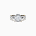 The 14K Two Tone Gold Diamond Cluster Engagement Ring features a central round diamond cluster, surrounded by a halo of smaller diamonds on an intricately designed band embellished with more diamonds.