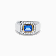 The Men's 14K Two Tone Gold East West Emerald Cut Tanzanite and Diamond Ring features a rectangular blue tanzanite set in a gold bezel, framed by white diamonds, all beautifully crafted against a plain white background.