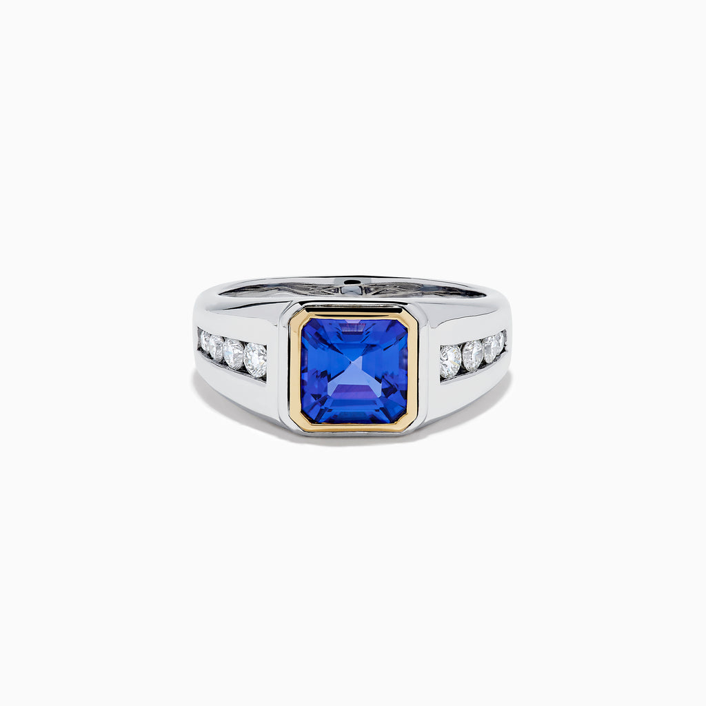 The Men's 14K Two Tone Gold Bezel Set Tanzanite and Diamond Signet Ring features a bold square tanzanite center, bordered by a gold bezel, and accented with small round diamonds on each side of the band.