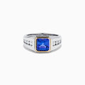 The Men's 14K Two Tone Gold Bezel Set Tanzanite and Diamond Signet Ring features a bold square tanzanite center, bordered by a gold bezel, and accented with small round diamonds on each side of the band.