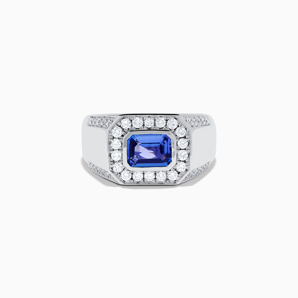 The Men's 14K White Gold East West Tanzanite and Diamond Signet Ring features a rectangular tanzanite center set among round diamonds in a bold geometric design, showcased on a white background.
