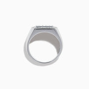 The Men's 14K White Gold Baguette and Round Diamond Signet Ring features a rectangular center set with four baguette-cut diamonds, bordered by smaller round diamonds, shown against a white background.