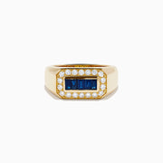 The Men's 14K Yellow Gold Diamond and Blue Sapphire Signet Ring features a bold rectangular center of blue sapphires, framed by round white diamonds in a symmetrical yellow gold setting.