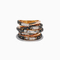 The 14K Rose Gold Black, White and Espresso Criss Cross Ring features five overlapping bands with alternating rows of sparkling black, white, and espresso stones in a bold criss cross design.