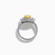 The 14K Two Tone Yellow Gold Yellow and White Diamond Halo Spiral Ring features a central square yellow gemstone, surrounded by a diamond halo with two rows of white diamonds in a sparkling circular spiral design.