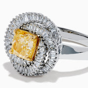 The 14K Two Tone Yellow Gold Yellow and White Diamond Halo Spiral Ring features a central square yellow gemstone, surrounded by a diamond halo with two rows of white diamonds in a sparkling circular spiral design.