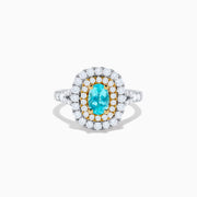 The 18K Two Tone Gold Paraiba and Diamond Double Halo Ring features an oval Paraiba centerpiece, surrounded by radiant yellow and white diamonds in a double halo, creating a striking layered effect.