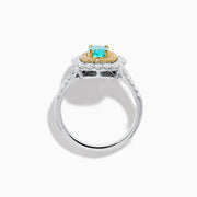 The 18K Two Tone Gold Paraiba and Diamond Double Halo Ring features an oval Paraiba centerpiece, surrounded by radiant yellow and white diamonds in a double halo, creating a striking layered effect.
