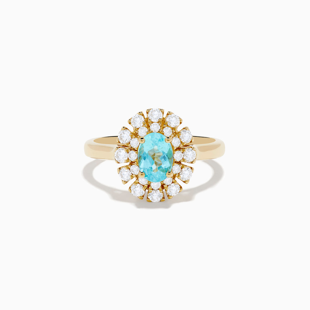 The 18K Yellow Gold Paraiba and Diamond Ring features an oval Paraiba gemstone at the center, encircled by a double halo of round diamonds, all showcased on a plain white background.