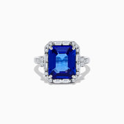 The Nahla Siri 14K White Gold Emerald Cut Tanzanite and Diamond Ring features a large emerald-cut tanzanite center, accented by baguette and round diamonds, displayed on a white background.