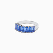 The Nahla Siri 925 Silver Tanzanite Band Ring features a row of rectangular blue tanzanites set across the top half of the band, crafted in refined sterling silver.