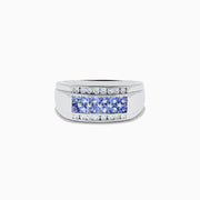 The Mens 925 Sterling Silver Tanzanite and Diamond Ring features a central row of round tanzanite gemstones accented by two rows of sparkling diamonds, all set in a wide, polished sterling silver band.