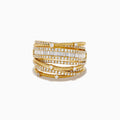 The 14K Yellow Gold Diamond Statement Crossover Ring features multiple overlapping bands with round and baguette diamonds, creating a striking, textured layered look against a white background.