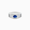 The 925 Sterling Silver Blue Sapphire and Diamond Ring showcases an oval blue sapphire centerpiece accented by two rows of sparkling round white diamonds along the band.