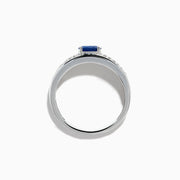 The 925 Sterling Silver Blue Sapphire and Diamond Ring showcases an oval blue sapphire centerpiece accented by two rows of sparkling round white diamonds along the band.
