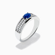 The 925 Sterling Silver Blue Sapphire and Diamond Ring showcases an oval blue sapphire centerpiece accented by two rows of sparkling round white diamonds along the band.