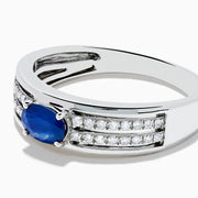 The 925 Sterling Silver Blue Sapphire and Diamond Ring showcases an oval blue sapphire centerpiece accented by two rows of sparkling round white diamonds along the band.
