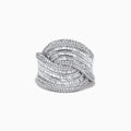 The 14K White Gold Diamond Statement Ring features overlapping, wavy rows of baguette and round diamonds, creating an elegant, textured design against a plain white background.