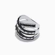The 14K White Gold Black and White Diamond Criss Cross Ring features overlapping bands set with alternating rows of black and white diamonds for a striking, modern look.