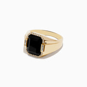 The Mens 14K Yellow Gold Onyx and Diamond Ring showcases a large rectangular onyx centerpiece framed by round diamonds, accented with two baguette-cut clear stones on each side.