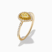 The Canare 14K Yellow Gold White and Yellow Diamond Ring features a pear-shaped yellow diamond with a white diamond halo and diamond-accented band, shown on a white background.