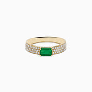 A 14K Yellow Gold Emerald and Diamond Ring featuring a rectangular emerald center with pavé-set diamonds along both sides of the band, displayed on a white background.