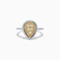 The Canare 14K Two Tone White and Yellow Diamond Ring showcases clustered yellow diamonds encircled by a double halo of white diamonds, set on a diamond-studded silver band for a striking, elegant look.