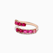 Crafted in 14k rose gold, this bypass ring showcases pink tourmaline and rubies totaling 1.49 TCW, accented by white diamonds in a spiral design.