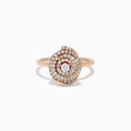 The Pave Rose 14K Rose Gold Diamond Rose Ring showcases a central round diamond encircled by concentric pave-set diamonds, creating an elegant spiral floral design.