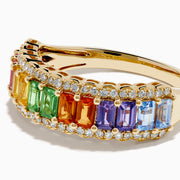 The Watercolors 14K Yellow Gold Multi Sapphire Baguette Band Ring showcases a row of rectangular rainbow sapphires, bordered by small round clear stones for a vibrant, elegant look.