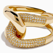 The D'Oro 14K Yellow Gold Diamond Interlocking Ring features a knot design, with one section accented by sparkling diamonds, beautifully displayed against a white background.