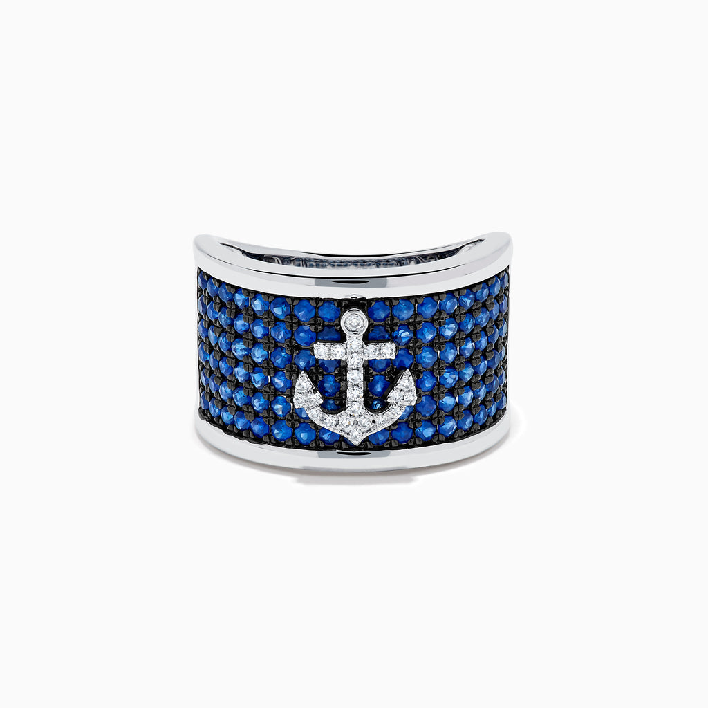 The Sterling Silver Blue Sapphire and Diamond Anchor Ring showcases a striking anchor center in clear stones, set on a white background with blue sapphires for added elegance.