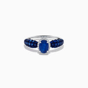 The 14K White Gold Blue Sapphire and Diamond Ring showcases a striking oval blue sapphire center, surrounded by sparkling diamonds, with additional sapphires set along the band.