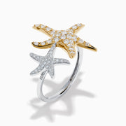The 18K Two Tone Gold Diamond Double Starfish Ring features overlapping gold and silver starfish set with sparkling diamonds on a sleek silver band, creating a striking two-tone look against a white background.