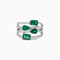 The 14K White Gold Emerald and Diamond Open Multi Row Ring showcases three bands set with diamonds and accented by large rectangular, square, and teardrop-shaped emeralds for a dazzling effect.