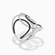The 14K White Gold Black and White Diamond Intertwined Ring features interlocking ovals set with alternating rows of black and white diamonds, displayed on a plain white background.