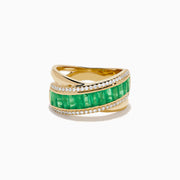 The 14K Yellow Gold Emerald and Diamond Crossover Ring features a central row of rectangular emeralds bordered by rows of sparkling white diamonds in an elegant crisscross design.